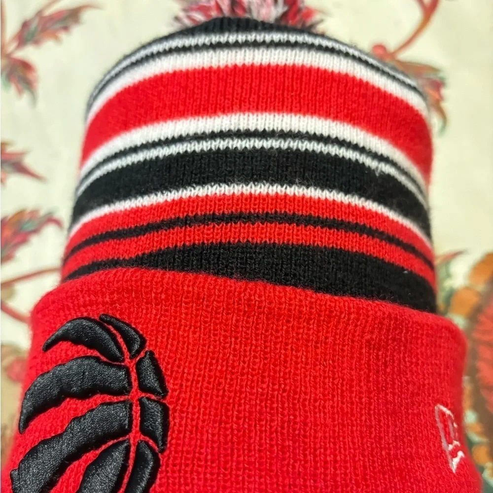 NEW ERA NBA TORONTO RAPTORS POM BEANIE STRIPED ADULT HAT RED BLACK MENS